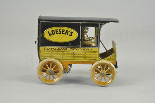 HANS EBERL "LOESERS TOYLAND" DELIVERY VAN: Germany, c. 1920, lithographed tin reads "Toyland Delivery," on sides, opening rear doors, clockwork driven, seated driver, a classic store promotional toy in colorful simulated wood panel litho. 7 1/