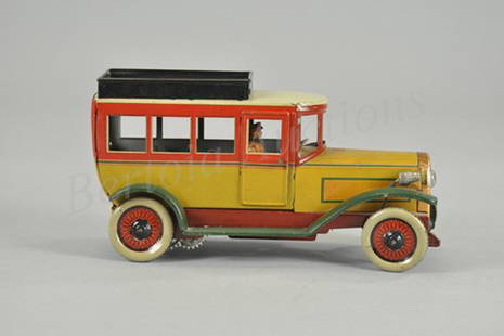 OROBR BUS: Germany, c. 1925, very colorful example, tin lithography done in yellow, red, green and cream, electric lights, clockwork driven, seated driver, interior features bench and solo seats. 9" l.