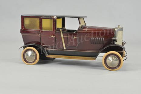 DOLL ET CIE TOURER SEDAN: Germany, c. 1920, body painted in brown overall, interior features bench seating and two solo seats, clockwork driven, celluloid windshield, nickel disc hubs, rubber tires, celluloid windows, top