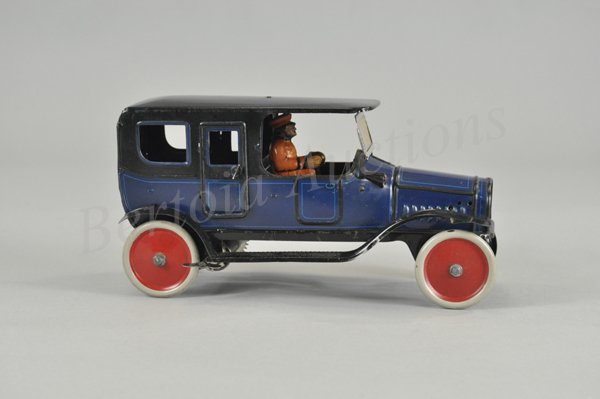 FISCHER LIMOUSINE: Germany, c. mid teens, lithographed tin, done in blue body, black fenders and roof, seated chauffeur, disc wheels done in white with red centers, clockwork driven. 10 1/4" l.