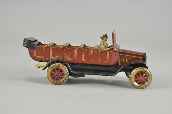 TIPP & CO. OPEN TOURING BUS: Germany, c. 1920's, lithographed tin, done in brown body, yellow striping, interior bench seating, simulated tin top down, seated driver, disc wheels, celluloid windshield insert, clockwork driven. 11