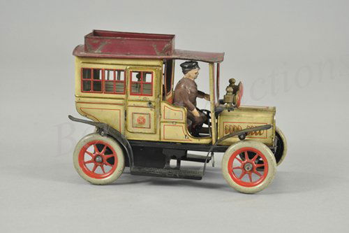 GUNTHERMANN LIMOUSINE: Germany, c. 1914, lithographed tin, well detailed with ornate windows sometimes called the Georgian window version, lanterns on front, seated driver, clockwork mechanism, opening passenger doors. 8" l