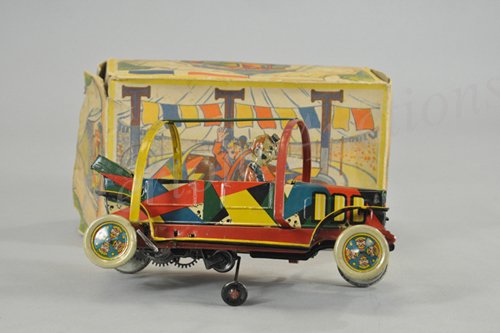 HANS EBERL TOPSY TURVY TOM AUTO: c. 1930's, colorful lithographed tin comical auto, features roll bars and clockwork action able to roll auto as it attempts to move forward, seated clown at wheel, very scarce box. 9 3/4" l.