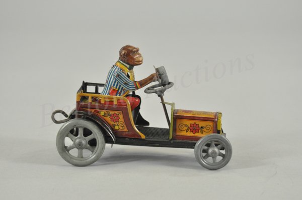 DISTLER AUTO WITH MONKEY DRIVER: Germany, c. 1925, very amusing lithographed tin toy, monkey with top hat in hand, able to tip wildly when clockwork is wound. 6 1/8" l.