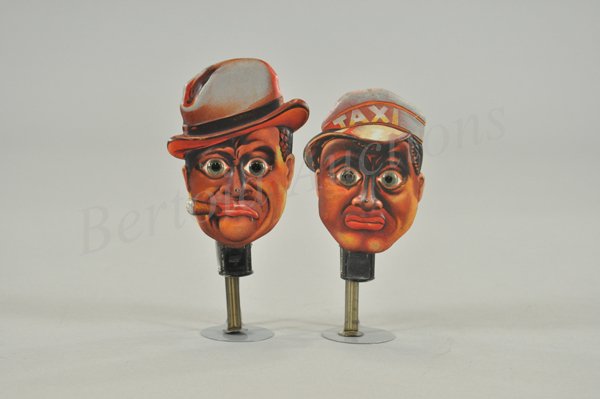 AMOS & ANDY SPARKLERS: Germany, pair of lithographed tin sparkling toys with glass eyes. Embossed faces convey the facial detail that makes them appear very real. Both work, but will need flints to spark. Marked Germany, ci