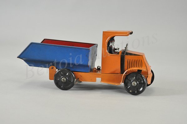 MARX MACK DUMP TRUCK: Lithographed tin, black 'C' cab done in orange, open blue dump body lifts for unloading, black disc wheels, seated driver, key wind operated. 13" l.