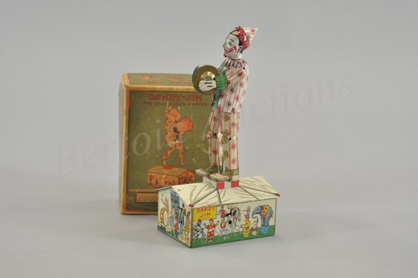 STRAUSS "DANDY JIM" THE JOLLY CLOWN DANCER IN ORI: Litho tin wind-up toy, working. Made by Strauss in the 1920s. Circus tent graphics are the stage for this cymbal playing clown. 10 1/4" h.
