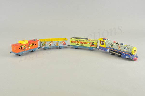 MICKEY MOUSE METEOR TRAIN SET: Litho tin wind up toy, working. Set includes engine and three cars lithographed all over in a most colorful and pleasing fashion with many different Disney characters. Cars have blue frames. Walt Disn