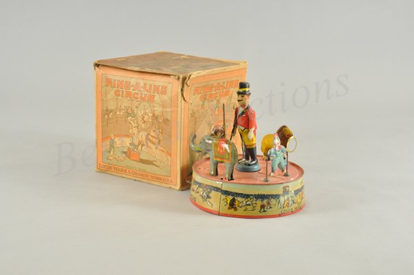 MARX RING-A-LING CIRCUS IN ORIGINAL BOX: Litho tin wind up toy, working. Pink top version. Outstanding box graphics and beautiful litho on tin. Circus scene in the center ring with ring master, three performing animals and a clown. Great eye