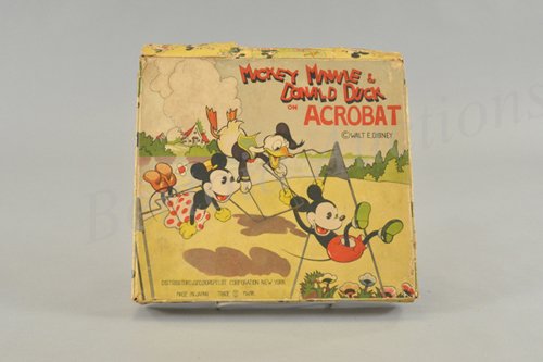 MICKEY, MINNIE AND DONALD TRIPLE TRAPEZE IN ORIGI: Celluloid wind up toy, working. Japan 1930's. Copyright Walt E. Disney and distributed by Geo. Borgfeldt. The three celluloid figures of Mickey, Minnie and Donald swing from the wire frame of the trap