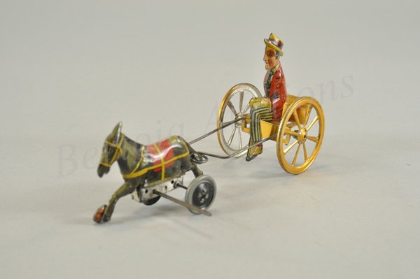 HAROLD LLOYD DONKEY CART: Litho tin wind up toy, working. Toy borrows the figure from the amusement park bumper car. Bright color litho, gold wash on cart and wheels. Unmarked but known to have been made in Spain c. 1928. 9" l