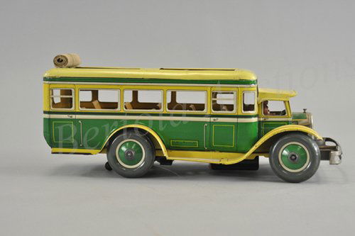 GUNTHERMANN ROLL TOP BUS: Germany, c. 1930's, a well detailed bus which features roll top roof, interior seating, done in lithographed tin, bright yellow and green color scheme, roof canopy over driver, superior stamping desig