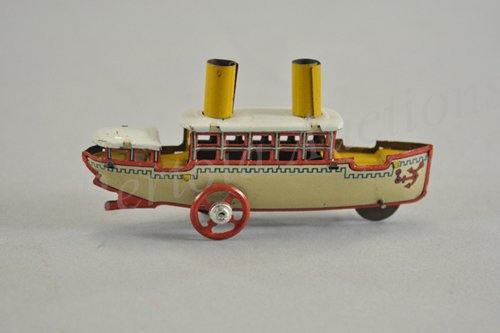 PASSENGER BOAT PENNY TOY: Meier, brightly done in cream, red and yellow-gold pattern, two smoke stacks at center, front wheel is fly mechanism. 4" l.