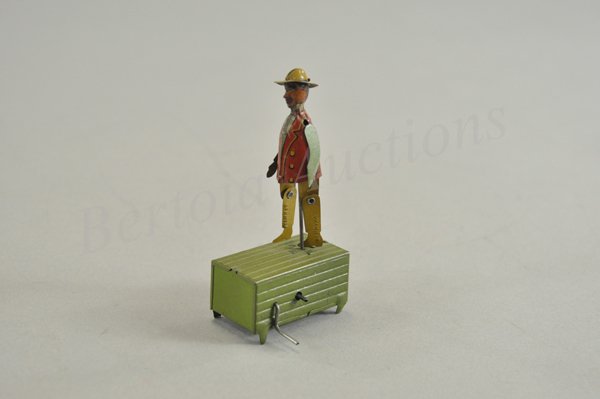 DISTLER TAP DANCER PENNY TOY: Germany, lithographed tin, small lever controls dancing motions, figure depicted on green box. 4" h.