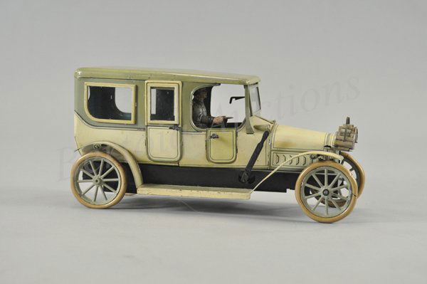 KARL BUB LIMOUSINE: C. 1914, Germany, lithographed tin, done in light green body, darker shade roof, extensive striping detail, opening windshields, clockwork driven, glass windows, all the classic appointments and rubbe