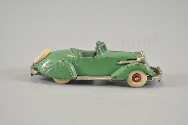 HUBLEY STUDEBAKER ROADSTER: c. 1935, cast iron, painted in green body, nickel chasssis, lights and bumper, spare rubber tire on trunk. 6 1/2" l.