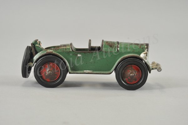 GLOBE COUPE WITH RUMBLE SEAT AND PASSENGERS: c. 1930's, rare cast iron example from obscure Philadelphia Co., painted in green body, opening seat contains two passengers, spare on rear, in 1985 a gentleman said he bought the building once owned 