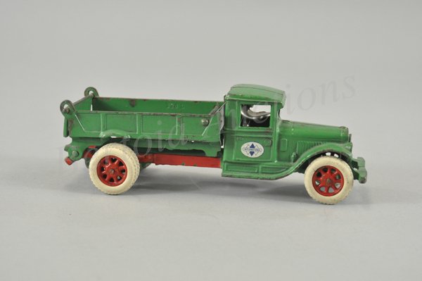 ARCADE INTERNATIONAL DUMP TRUCK: c. early 1930's, cast iron, painted in green body, red frame, side lever allows tilting for body unloading, opening tailgate, International decals on door, Arcade decal in dump bed, seated driver, rub