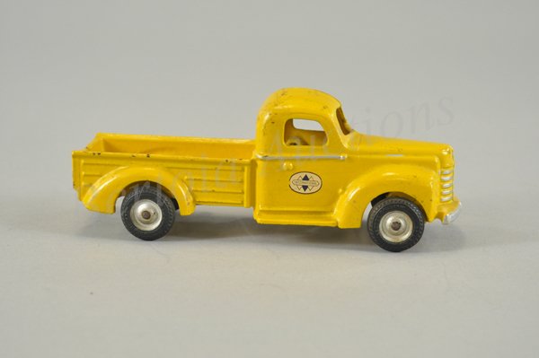 ARCADE INTERNATIONAL PICK-UP TRUCK: c. 1940's, cast iron, painted in bright yellow, well scaled, International decals on doors, Arcade decal on bed, black rubber tires, classic example of early pick-up toy. 9 1/2" l.