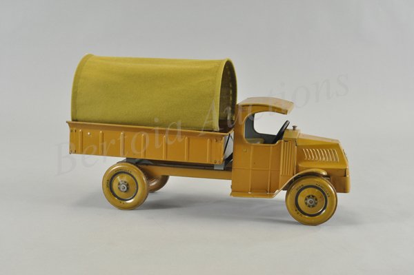 CHEIN COVERED ARMY TRUCK: c. 1929, "C" Cab Mack with low open bed and canvas cover, painted in khaki overall, tin lithographed wheels marked, "Hercules," grille contains litho emblem. 19 1/4" l.