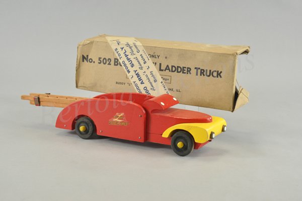 BUDDY "L" LADDER TRUCK WITH ORIGINAL BOX: 1940's, wood example, yellow grille area, red cab and open service body, contains extension ladder supported on open bed, decals on sides, No. 502 box has Army Supply label over exterior. 15 1/2" l.