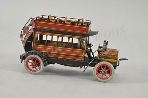 GUNTHERMANN DOUBLE DECKER BUS: Germany, c. 1920's, lithographed tin, well detailed with hood mounted lanterns, seated driver, upper deck seating and front crank lever for clockwork activation. 10" l.