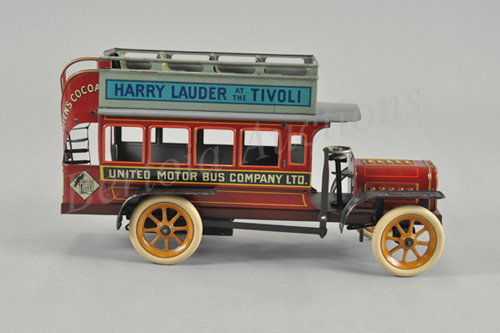 BING "HARRY LAUDER" BUS: Germany, c. 1911, well detailed overall, extensive graphic advertising, upper deck seating and rear stairwell, spoke wheels, rubber tires, clockwork driven. 11 1/2" l.