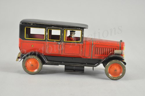RARE PRE-WAR JAPAN SEDAN: Lithographed tin, red body, black roof, clockwork driven, interior seating, electric lights, "623" appears on embossed grille, a very early Don find from Brimfield. This auto is an almost exact copy o