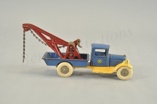 KILGORE WRECKER: c. 1931, cast iron, enclosed cab and low side service body painted in blue, cream colored fenders, red boom has chain hoist and nickel lever, rubber tires, nickel axles. 11" l.