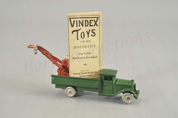 VINDEX AUTO WRECKER: c. late 1920's, scarce example, cast iron, painted in green overall, features a red crane and billed originally as a real working outfit, nickel plated disc wheels, includes Vindex pamphlet of toys. 1