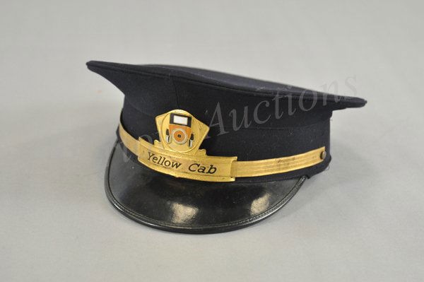 YELLOW CAB DRIVER'S HAT: Original cabbie's cap, done in blue cloth, hard black rim and very decorative Yellow Cab insignia, surrounding brim is gold finished color metal.