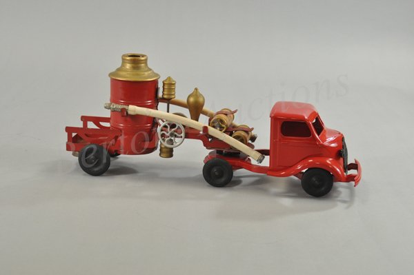 KINGSBURY STUDEBAKER FIRE TRUCK: c. 1938, pressed steel, cab and fire pumper service body done in red, cab over engine tractor has plated grille, express trailer has upright boiler and rear platform. 20 1/2" l.