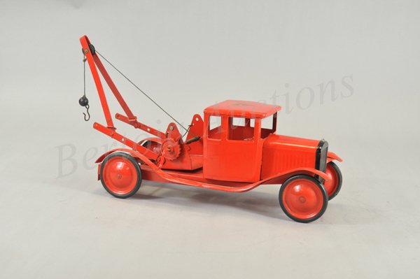 TRI-ANG WRECKER: c. 1930's, pressed steel, painted in red overall, boom appears on open service frame, disc wheels, rubber tires, decal on hood. 17" l.