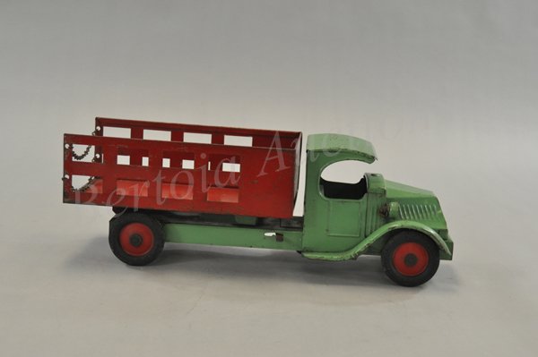 STEELCRAFT METAL MASTER RAPID DELIVERY: Pressed steel, electric lights, Mack 'c' cab painted in green, stake side body done in red, decal reads 'Master Rapid Delivery,' embossed rubber wheels, chained tailgate. 20 1/2" l.
