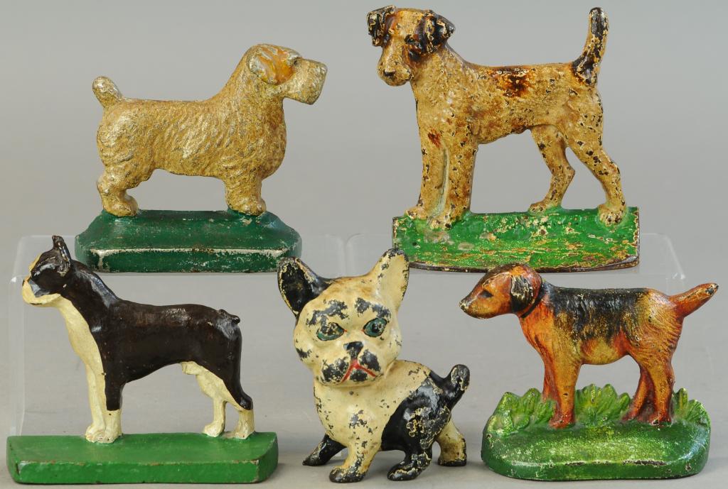 GROUPING OF DOG THEME DOORSTOPS: 299. GROUPING OF DOG THEME DOORSTOPS | 5" - 6" l. | All Original Condition. | $250 - $500
