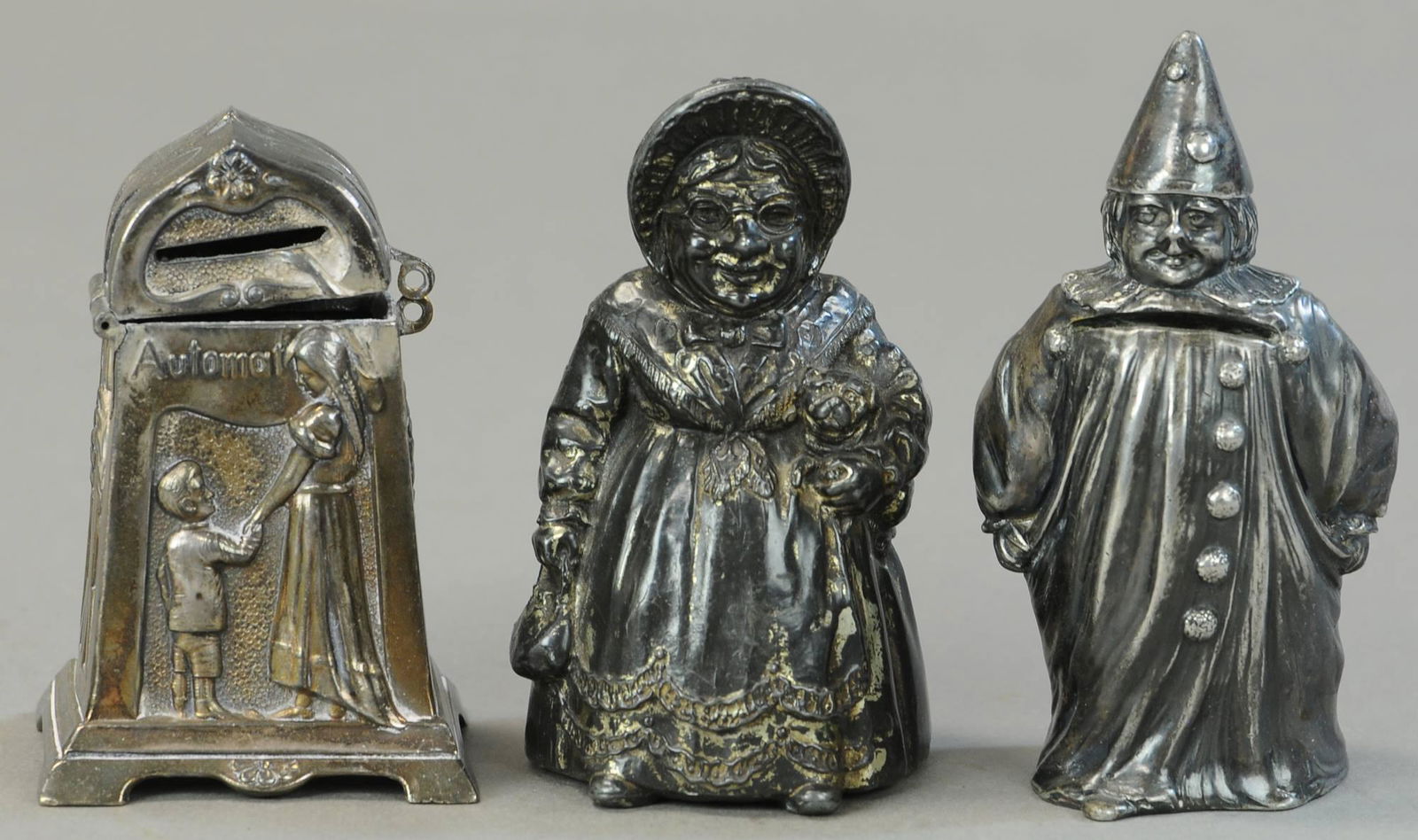 THREE FIGURAL SILVERED LEAD STILL BANKS (1 of 3)