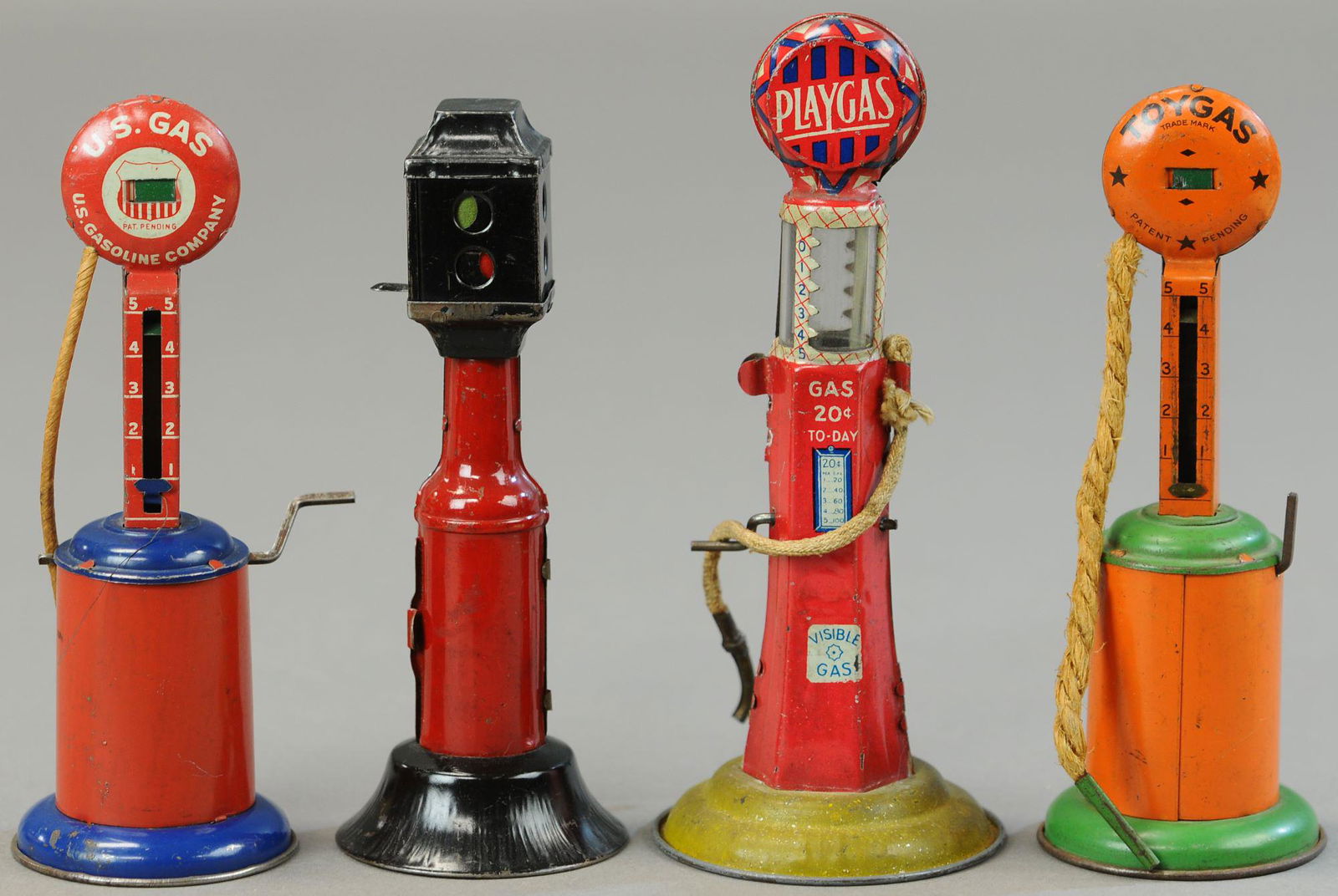 FOUR MIXED TIN PUMPS AND TRAFFIC LIGHT (1 of 3)