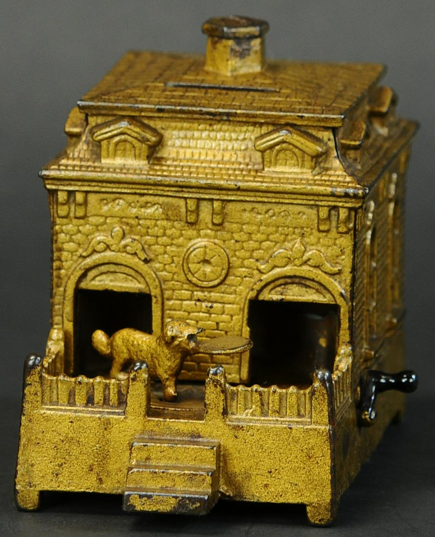 DOG ON TURNTABLE MECHANICAL BANK: 688. DOG ON TURNTABLE MECHANICAL BANK | Judd Mfg. Co., circa 1870's, gold painted version. Provenance: The Schroeder Collection. | (Excellent Condition) | $400 - $600