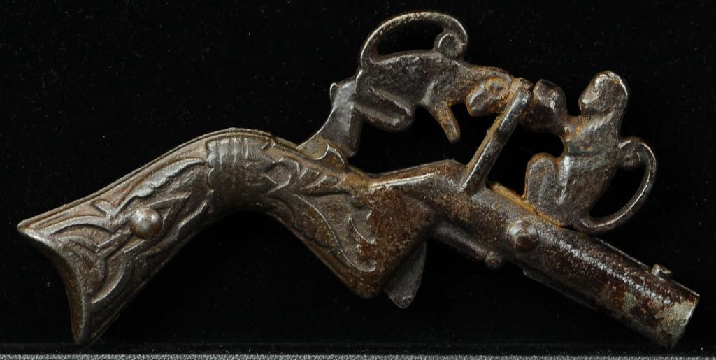 MONKEYS ANIMATED CAP GUN: 888. MONKEYS ANIMATED CAP GUN | Lockwood, monkey's head hits coconut causing cap to explode. Provenance: The Schroeder Collection. | 4" l. | (Excellent Condition) | $600 - $900