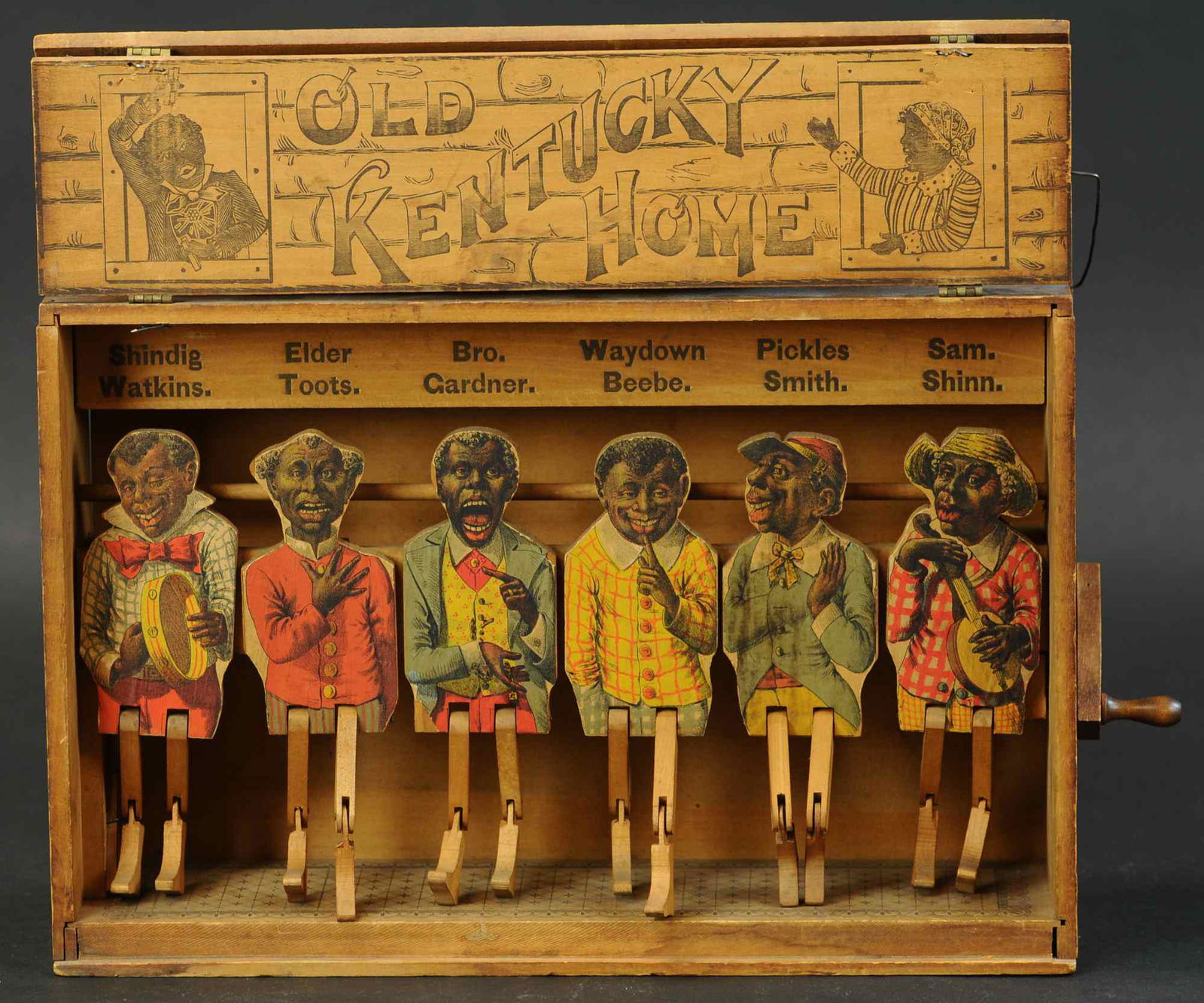 OLD KENTUCKY HOME JIGGING TOY: 1436. OLD KENTUCKY HOME JIGGING TOY | W.S. Reed Co., c. 1878, a rare paper on wood lithographed toy depicting five dancing men on wood framed stage with side hand crank. Provenance: The Schroeder Coll