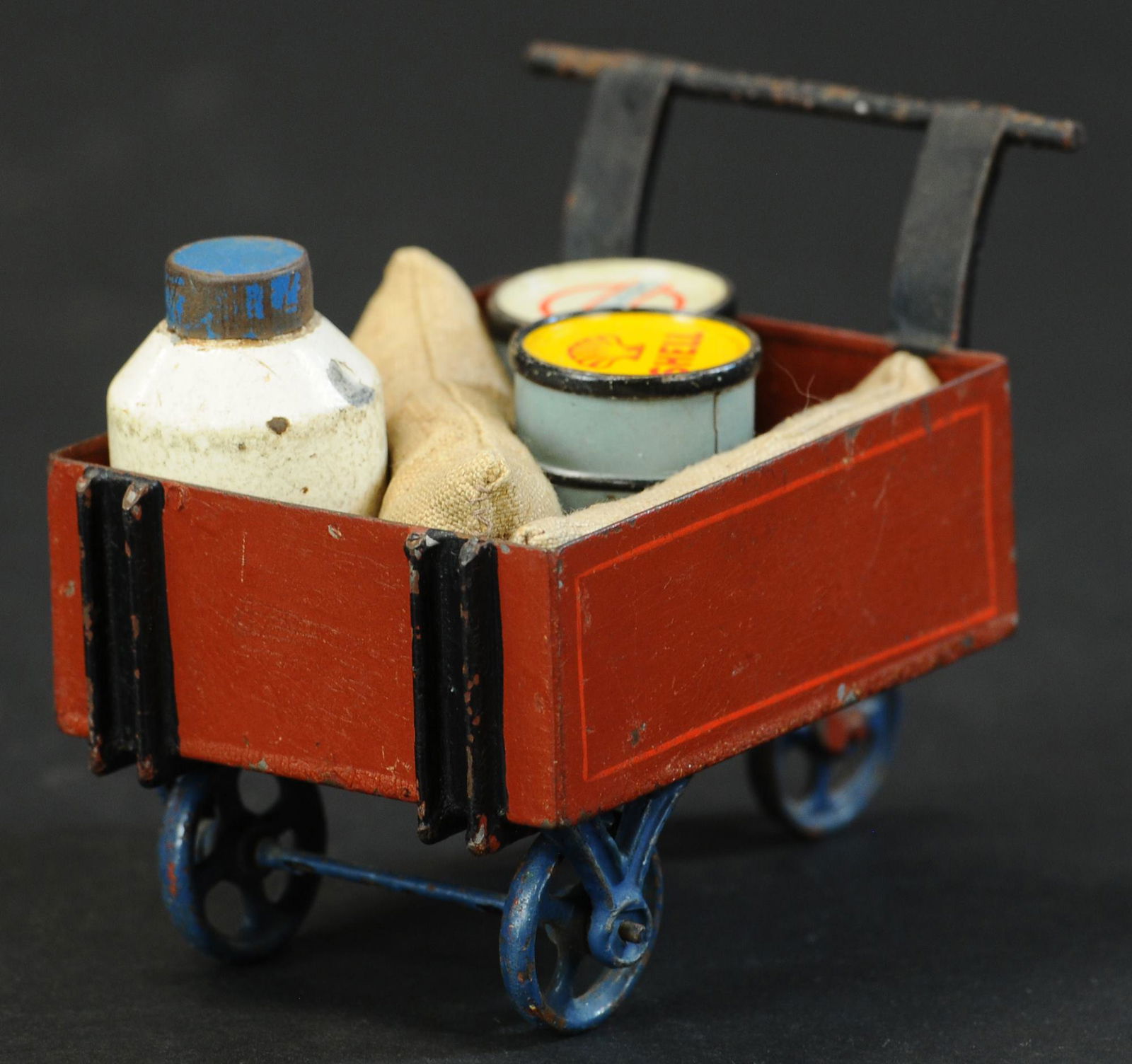 MARKLIN LUGGAGE CART: 1402. MARKLIN LUGGAGE CART | 5" l. | Provenance: Paul Cole Collection. | Oil drums are original, milk drum is replaced, cart in (Very Good Condition) | $150 - $300