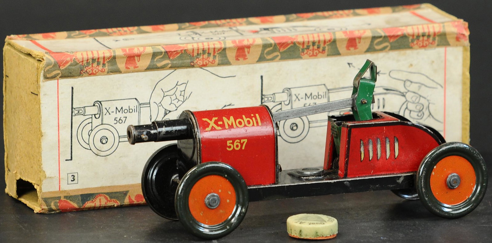BOXED HESS X-MOBIL CANNON CAR: 880. BOXED HESS X-MOBIL CANNON CAR | Instructions appear on box sides, cock cannon back to expose a circular place for cap placement, interesting piece. | 9.5" l. | Provenance: Paul Cole Collection. |