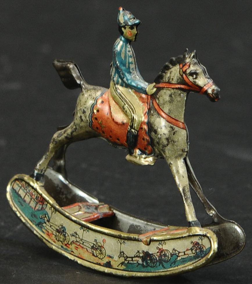 MEIER ROCKING HORSE JOCKEY PENNY TOY: 365. MEIER ROCKING HORSE JOCKEY PENNY TOY | 3.5" h. | (Exc. Cond.) | $200 - $300