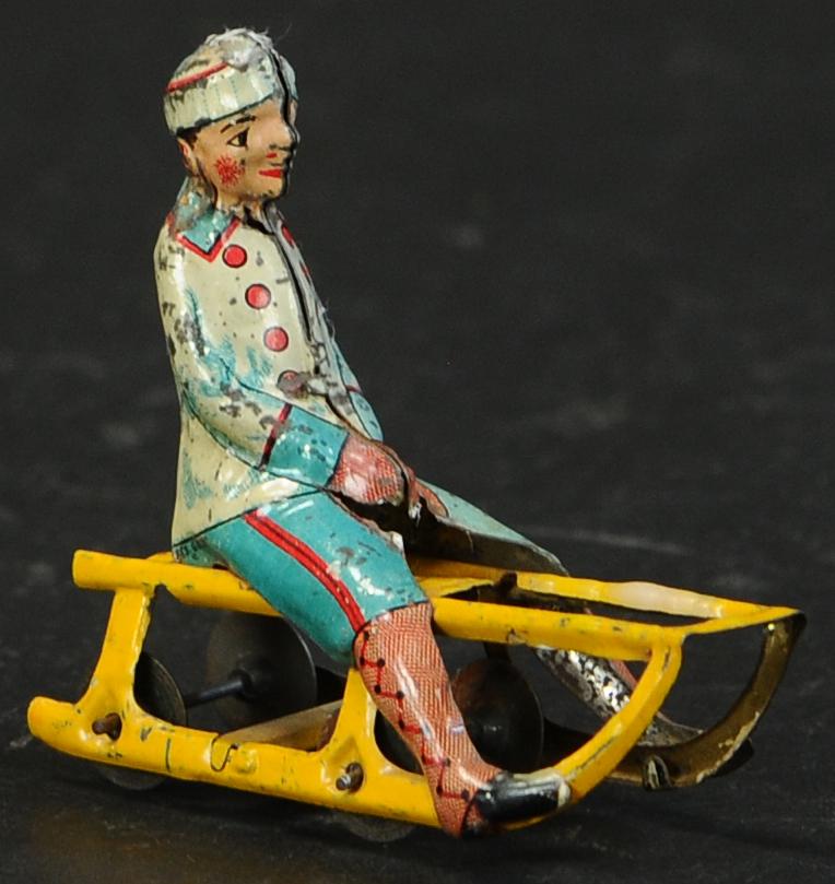 MEIER BOY ON SLED PENNY TOY (1 of 3)