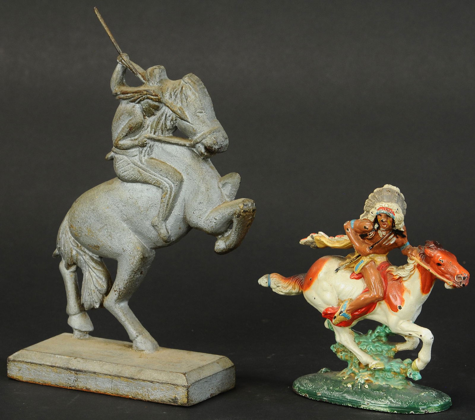 TWO CAST IRON WILD WEST THEMED DOORSTOPS: 1496. TWO CAST IRON WILD WEST THEMED DOORSTOPS | Full figured painted Indian on horseback, and rare unpainted Indian on bucking horse. | 6"-10" h. | (Exc. - Pristine Cond.) | $300 - $500