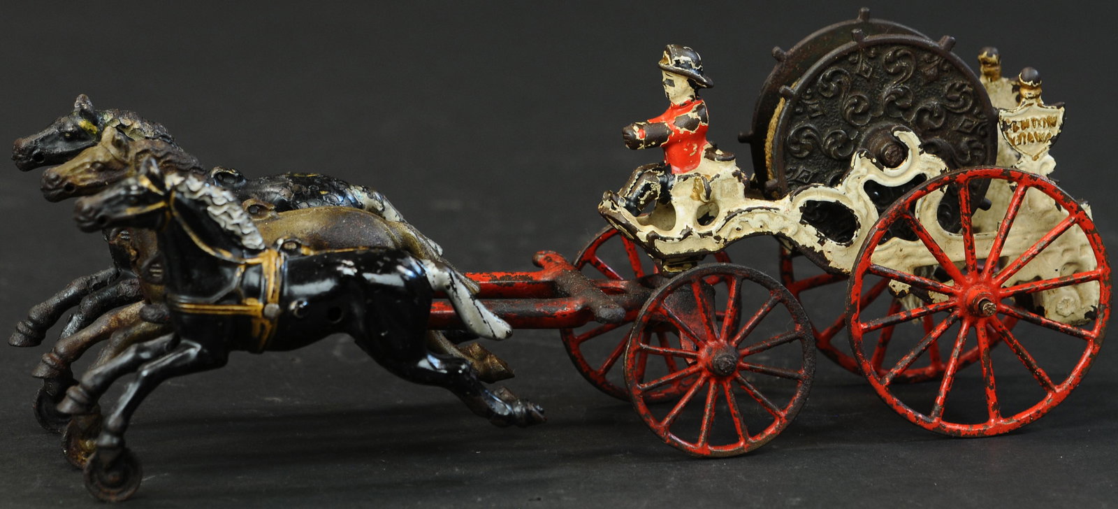 KENTON 1910 HOSE REEL: 1543. KENTON 1910 HOSE REEL | Provenance: Edward & Norma Lotz Collection. | 14" l. | Hairline crack to outside of one rear wheel. (VG Cond.) | $500 - $750