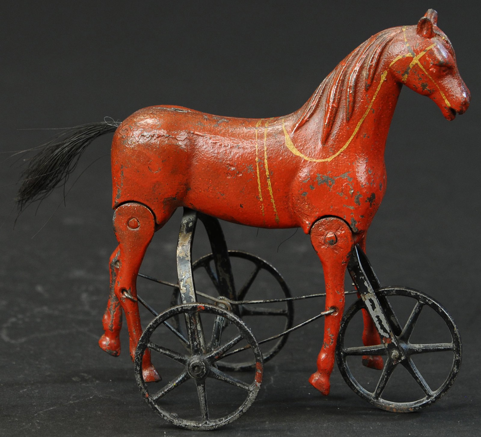 IVES THREE WHEELED WALKER HORSE: 1570. IVES THREE WHEELED WALKER HORSE | Ex. Max Berry Collection to Edward & Norma Lotz Collection. | 8" l. | Missing original tail. (Exc. Cond.) | $2,000 - $3,000