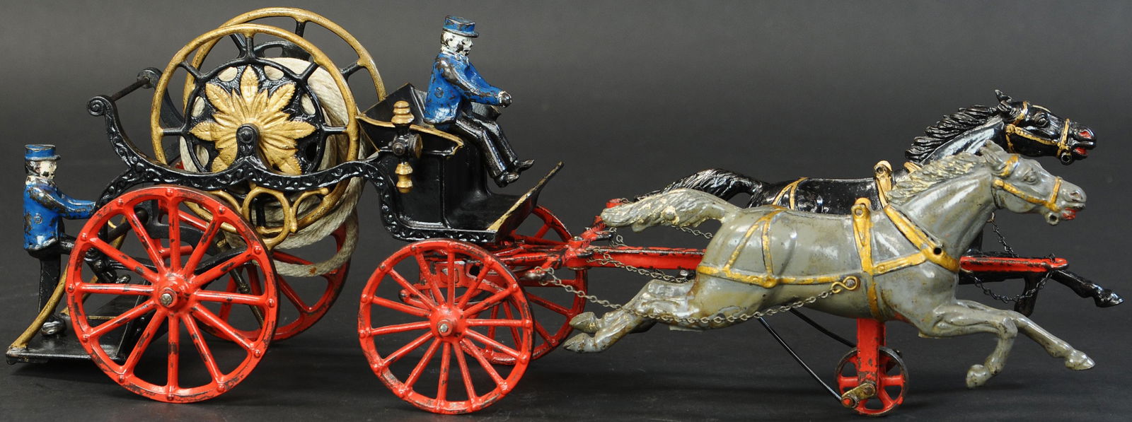 RARE IVES OVERSIZED 1912 HOSE REEL: 1577. RARE IVES OVERSIZED 1912 HOSE REEL | Provenance: Edward & Norma Lotz Collection. | 25" l. | Tip of one ear on black horse chipped, two factory cracks at receiver of hitch, repair to left side of