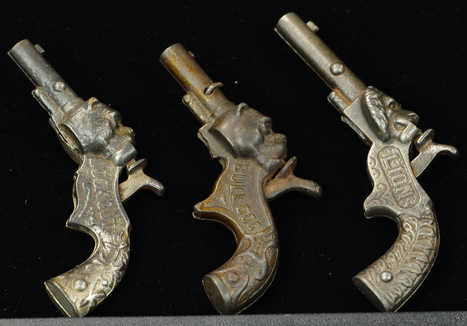 LION, BULLDOG & LOOK OUT FIGURAL CAP GUNS: 1589. LION, BULLDOG & LOOK OUT FIGURAL CAP GUNS | 5" l. | Bulldog rivet was replaced with nail, overall (VG - Exc. Cond.) | $300 - $500