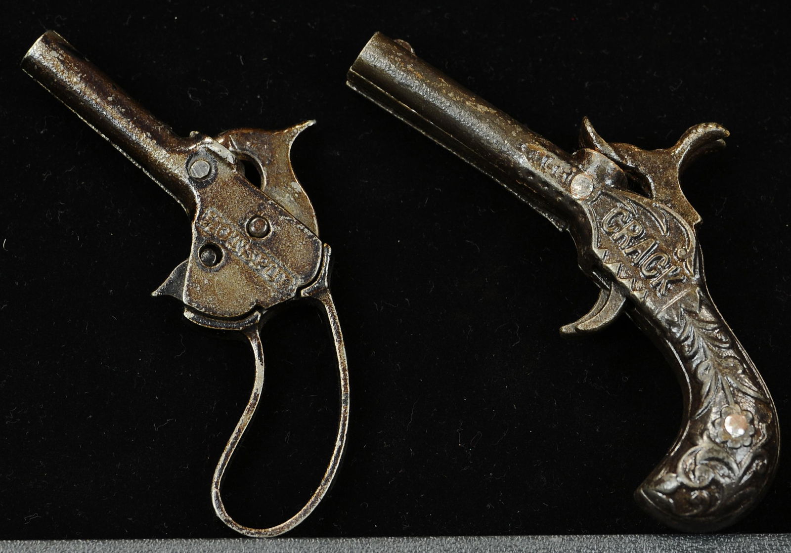HOT SPUR AND CRACK CAP GUNS: 1592. HOT SPUR AND CRACK CAP GUNS | Double barrel crank and hot spur cap guns. | 4.5" l. | (Exc. Cond.) | $200 - $300